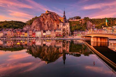 Dinant reflection on the Meuse river at twilight 