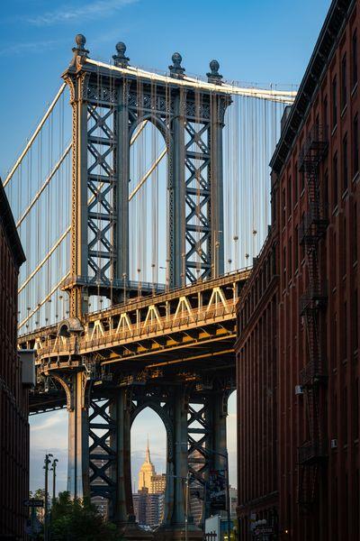 images of New York City - Empire State Building view through the Manhattan Bridge