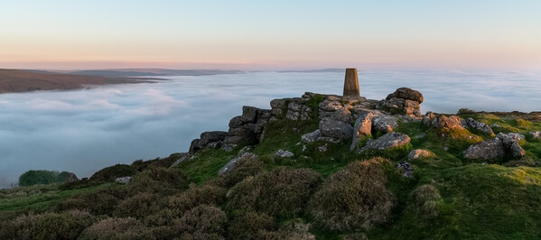 The view of the trig point looking north to Cosdon Hill on a spring sunrise during a temperature inversion.