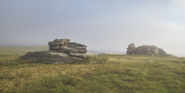 Some of the rock stacks at Wild Tor on a foggy sunrise in summer.