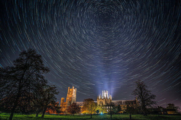 Star trails work well, as Polaris is directly above the illuminated tower