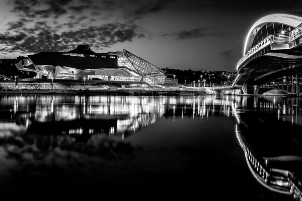 The Confluences museum and the Raymond Barre footbridge on the Rhone at Lyon in the Confluences district in B/W.