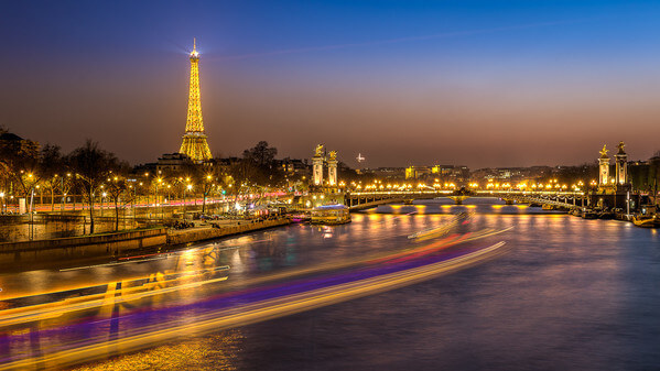 Blue hour on  the Eiffel Tower ( "Copyright Tour Eiffel - illuminations Pierre Bideau") and the Pont Alexandre III seen the Pont de la Concorde.
In the background, you can also see the Palais de Chaillot.