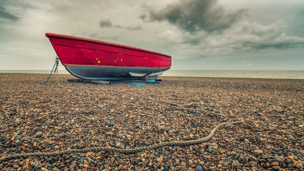 The little red boat in winter, overcast day