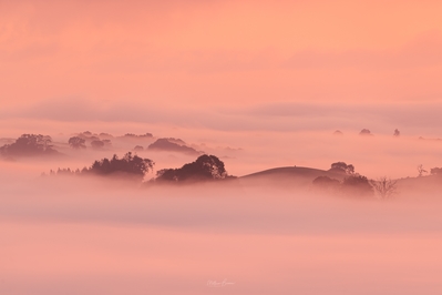 Layers of fog in the valley at sunrise