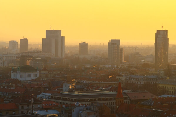 Cityscape with rooftops and Vjesnik, Zagrepčanka and Cibona towers during sunset