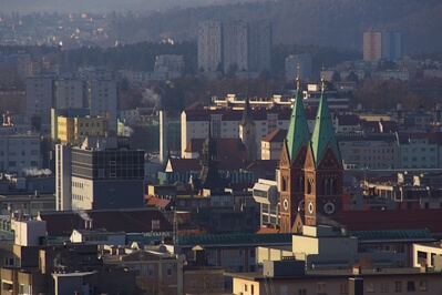 Center of Maribor with Slavija business building and Franciscan church in winter morning