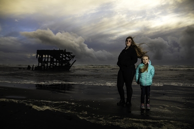 Sunset portrait in winter at Fort Stevens. Off camera flash and under exposed by 1 stop.