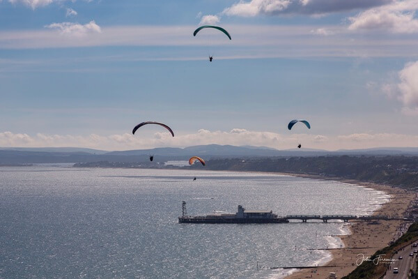 Paragliders above the pier