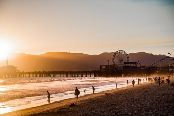 Sunset over Santa Monica Pier closer to the beach from the exercise area.