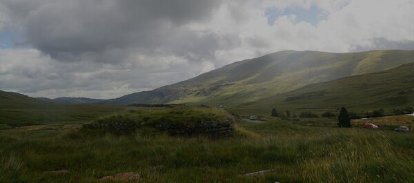 Former wartime pill box blending with local hills, contours,  road, and Moel Siabod to right.