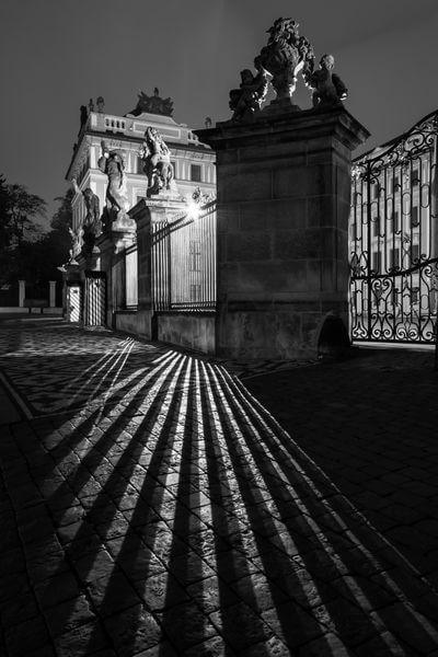 Night play of shadows in front of the Wrestling Titans statues on the Prague Castle