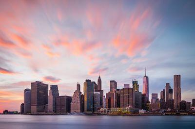 Beautiful sunset-colored sky above the Lower Manhattan panorama, as seen from the Pier 1