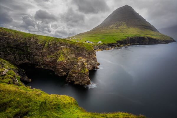 Viðareiði village with the cliffs