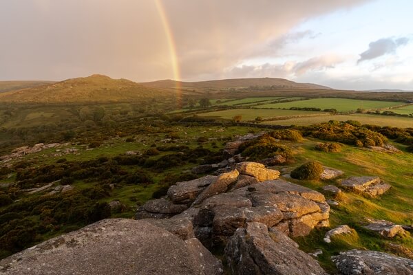 A pink sunrise rainbow looking north west towards Sharp Tor on a spring sunrise.