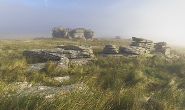 Some of the rock stacks at Wild Tor on a foggy sunrise in summer.