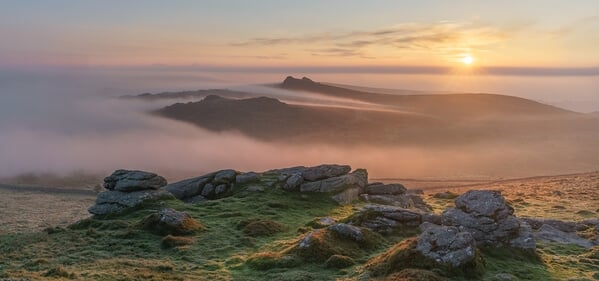 Summit of Rippon Tor looking north east on a late spring sunrise during an inversion and hill fog.