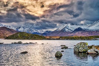 Sunset over the snowy mountains behind Lochan na h-Achlaise