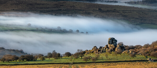 A spring sunrise with early morning mists, looking south, using a telephoto lens, from Stale Tor lower slopes.