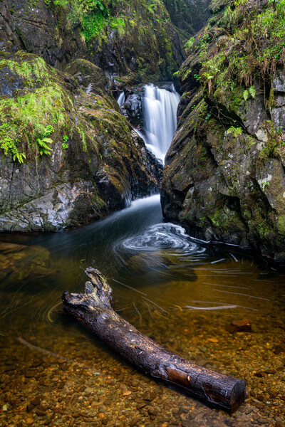 A log makes good foreground with the lower cascade of Aira Force in the background