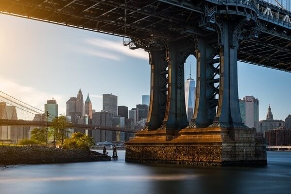 View of the Lower Manhattan vith One WTC framed by the pillar of the Manhattan Bridge.