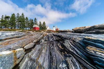 A low view with a wide angle lets you lead up to the lighthouse with the lines in the rocks