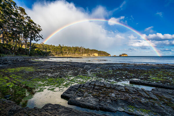 Tessellated Pavement, Tasmania, photographed some time before sunset. I was complaining about the rain for some time .... but not for too long :-) I wish I had my tripod ready for some longer exposure tries, but it took too long and the rainbow was as quickly gone as it appeared.