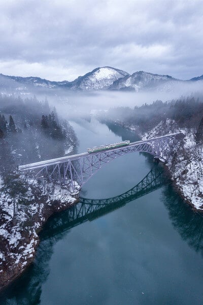 A drone photo of the bridge with a local train.