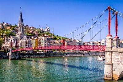 St Georges footbridge on the Saone in Lyon. It connects the Prequel district and the St-Georges district. On the bank oposed, we can see the Church of St. George and the Basilica and the Tower of Fourviere in the background.
Likewise, the color of the houses is enhanced by the sunlight.