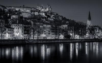 Blue Hour on the Saone and the St-Georges district at Lyon in B/W view from the banks of Saone. 
In the background, you can see St George's Church and St George's Bridge, as well as the Basilica of Fourviere.