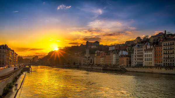 Sunset on the Saône at Lyon view from the Bonaparte bridge. In the background, we can see the footbridge and the church St-Georges.