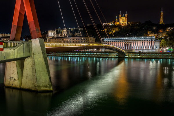 Footbridge of the courthouse on the Saone at Lyon by night 
It connects the peninsula to the Old Lyon at the old courthouse. On the opposite bank, we can see the old courthouse, the Cathedral St Jean Baptiste and the Basilica and the tower of Fourviere.