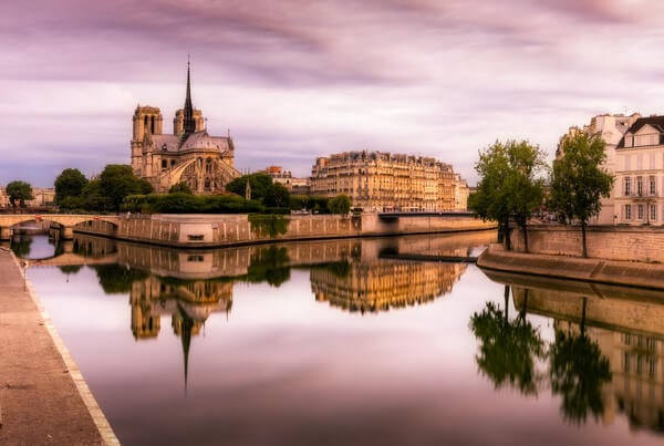 Magic colors of the end of the blue hour, in the morning, on the Ile de la Cité and the Cathedral Notre Dame of Paris seen from the Tournelle bridge. The calm Seine that morning allowed me to have this reflective effect.