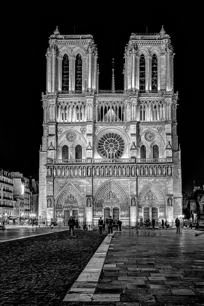 Cathedral Notre Dame de Paris seen from the Parvis Notre Dame - Place Jean-Paul II at the night in B/W.