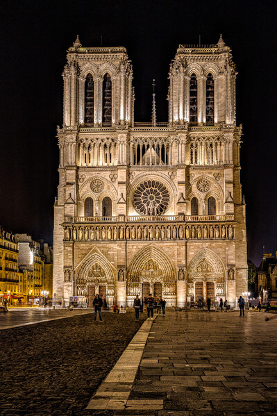 Cathedral Notre Dame de Paris seen from the Parvis Notre Dame - Place Jean-Paul II at the night.