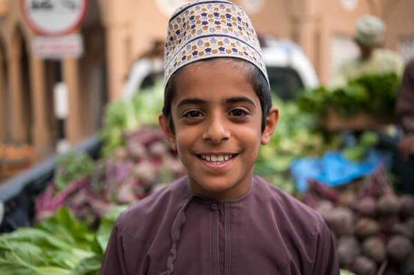 Omani boy selling vegetables