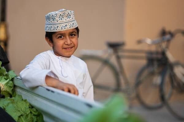 Omani boy helping his dad