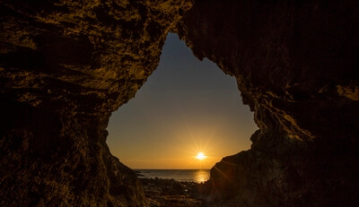 Image 3 ~ This image is captured using a tripod and a long exposure. Your aperture should be around f16 or f22 to keep both the cave interior and the setting sun, sharp. Keep your iso as low as possible to minimise 'noise'.