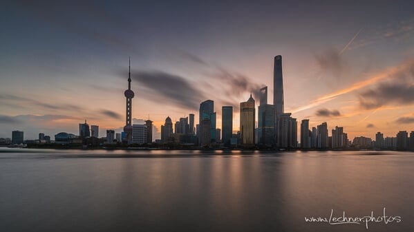 get yourself up early and watch the sun rise over Pudong. Add in some clouds and some ND filter - wow! For me it beats the shiny glamourous evening light show by far.