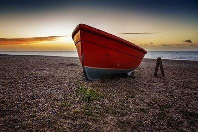 Small red boat on the beach