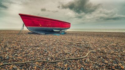 The little red boat in winter, overcast day