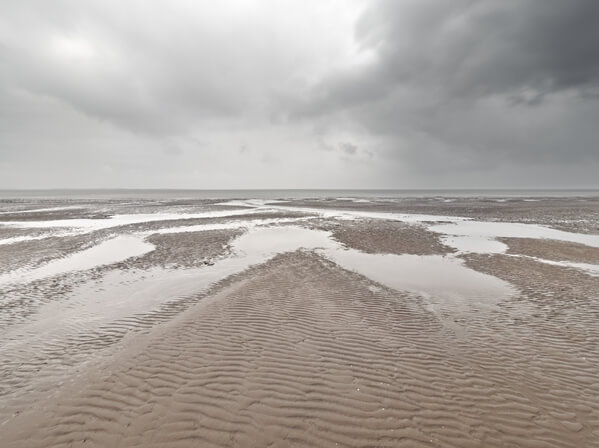 Pools of sea water left in the mudflats near Burnham-on-sea Low Lighthouse