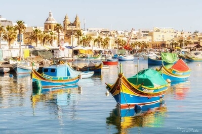 Malta's typical, colorful fishing boats are called luzzu and make for an interesting subject in Marsaxlokk's harbor.