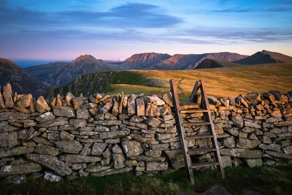 A lovely drystone wall not far from the summit with a perfectly placed style beckons you to walk onwards towards Tryfan.
