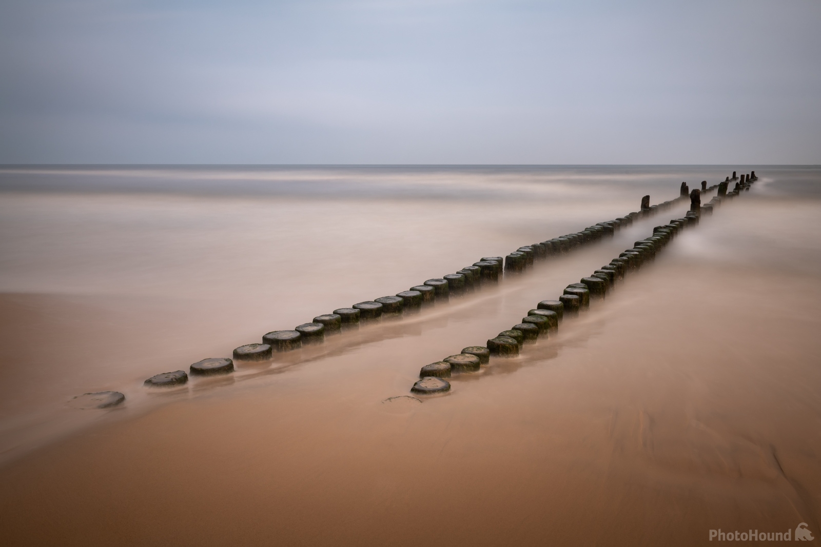 Image of The wooden pillars by the Heringsdorf Pier by VOJTa Herout
