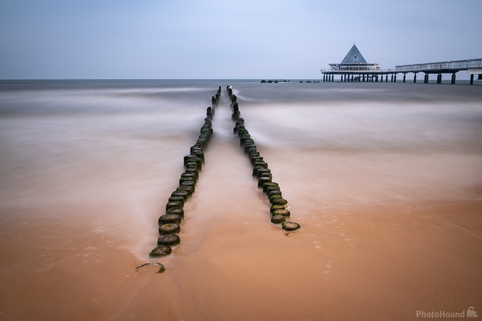 Image of The wooden pillars by the Heringsdorf Pier by VOJTa Herout