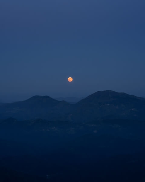 Full moon rising between Porezen and Blegoš