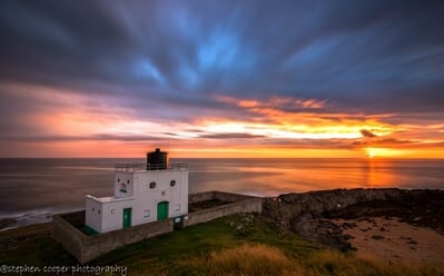 bamburgh light house located on stag rock (sunrise)