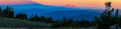 Stitched panorama of 4 images showing Mount Saint Helens and the shadow of Mount Adams at sunrise.