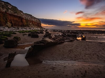 Old Sheraton steam ship wreck and Hunstanton Cliffs during the sunset.